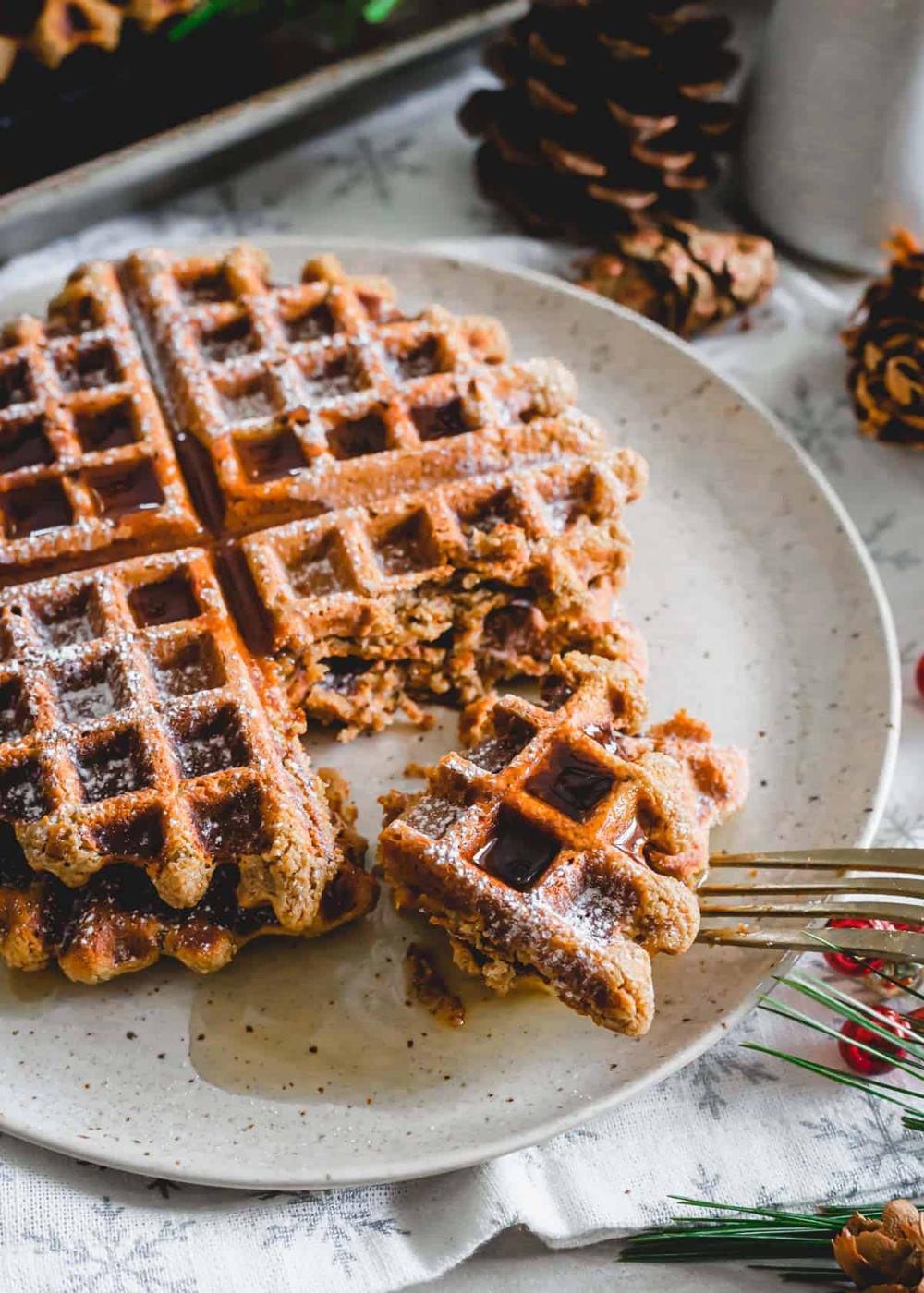 Gingerbread molasses waffles cut into pieces on a plate.