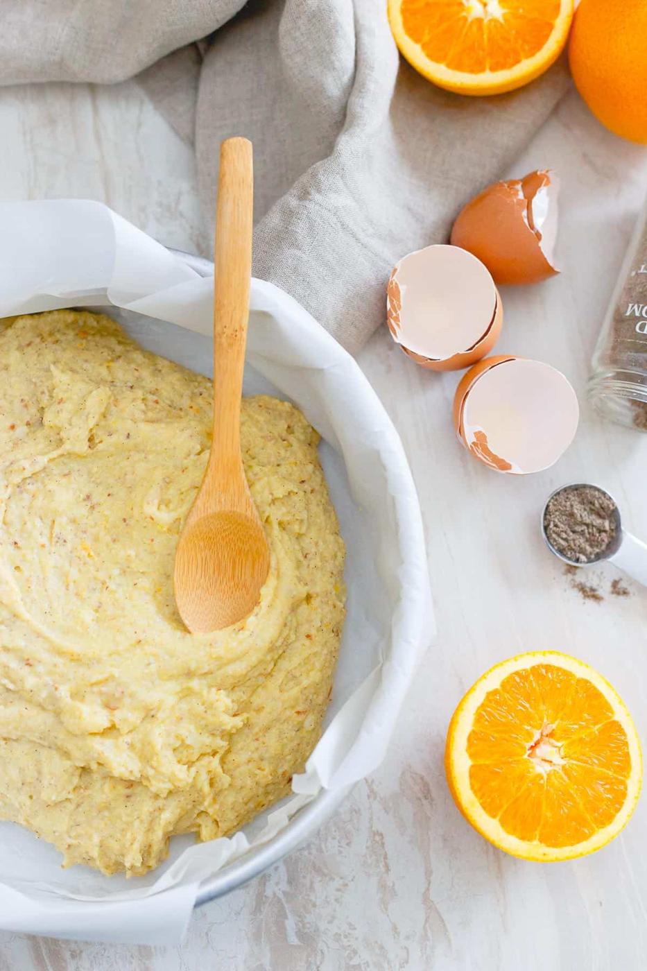 This simple winter cake is bursting with orange flavor and cardamom spice. Brushed with a sweet sticky glaze, it's simplistic yet delicious.