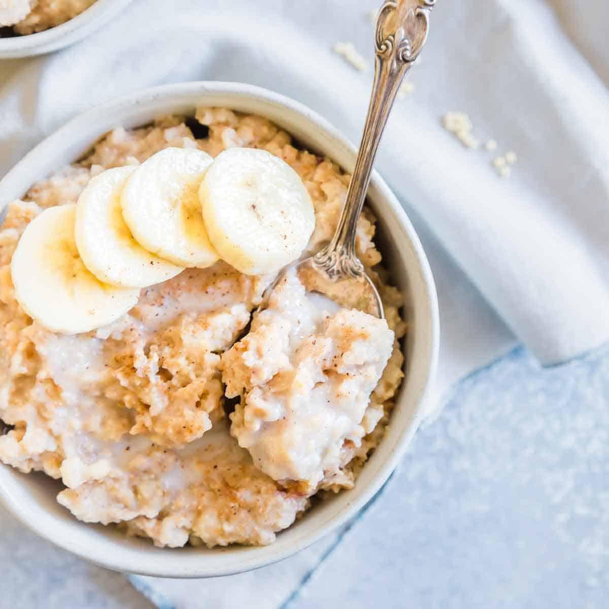 Millet porridge in a small bowl with banana slices.