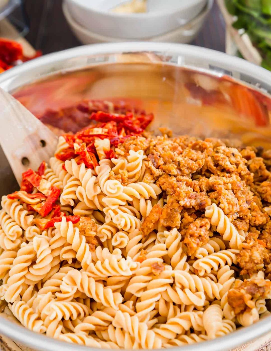 Sun-dried tomatoes and sautéed mushroom veggie burgers give this creamy white bean pasta tons of flavor and texture.