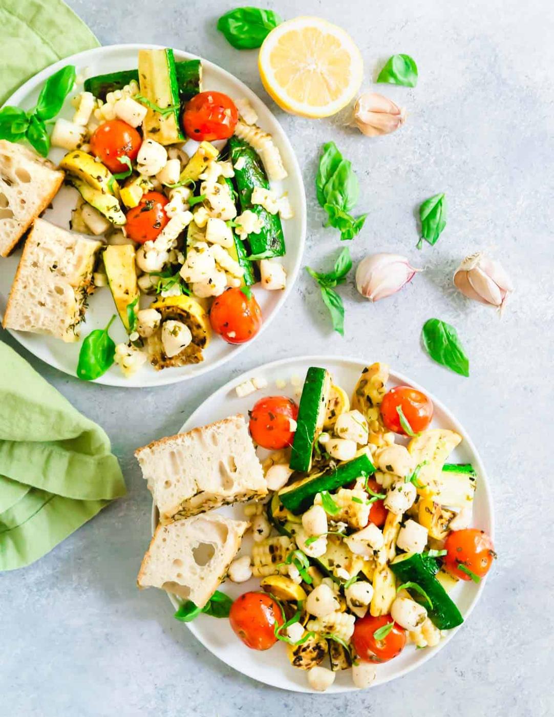 A simple, quick and easy summer meal - grilled bay scallops with zucchini, summer squash, tomatoes and corn in a basil butter sauce.