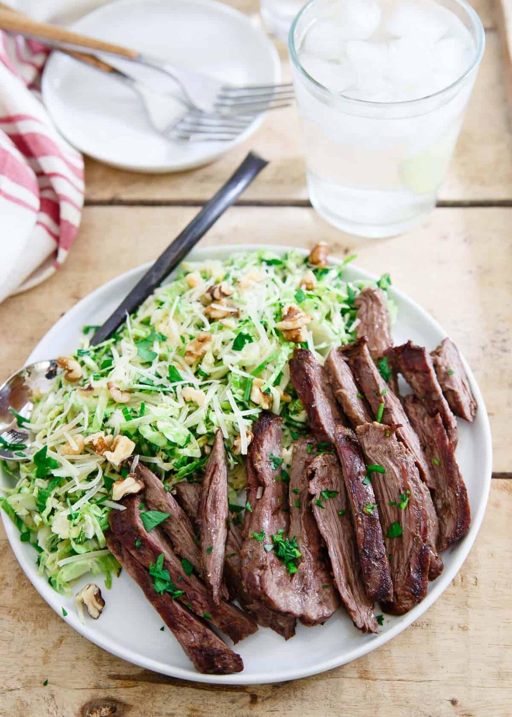 This grilled skirt steak is the perfect summer meal served with a chopped brussels sprouts salad tossed in a lemon dijon dressing.