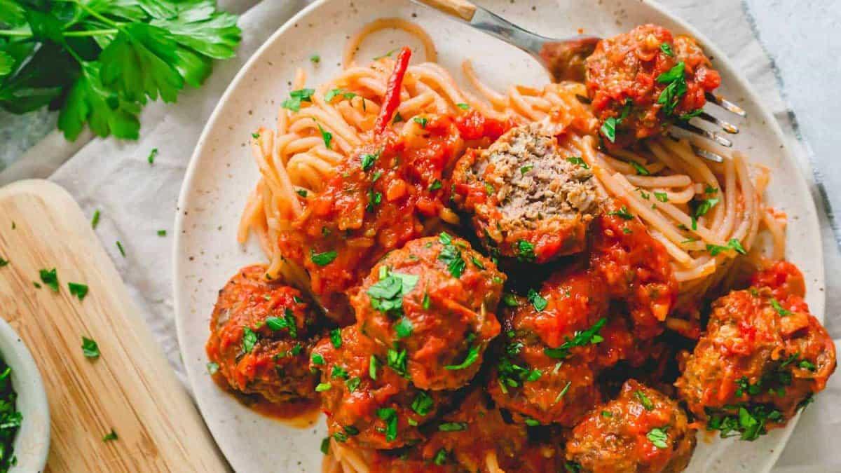 Spaghetti with meatballs and sauce on a plate.