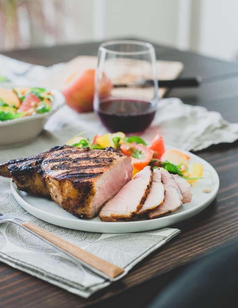 Fire up the grill and get these harissa rubbed pork chops on before summer's over. Paired with a tomato peach salad, it's a simple but satisfying meal.