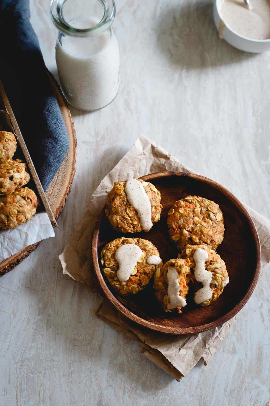 Real carrots, raisins, ginger, lemon zest and walnuts are packed into these healthy carrot cake cookies drizzled with a cream cheese almond butter icing.