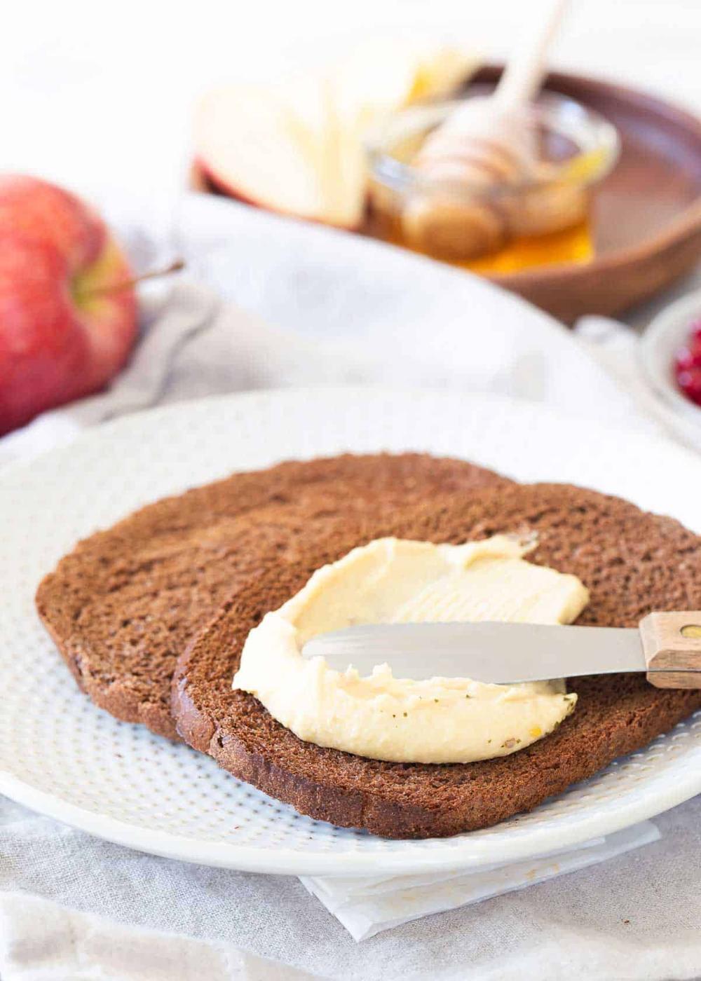 Hummus toast is such an easy snack or quick breakfast. This fruit version has honey drizzled apple slices and pomegranates.