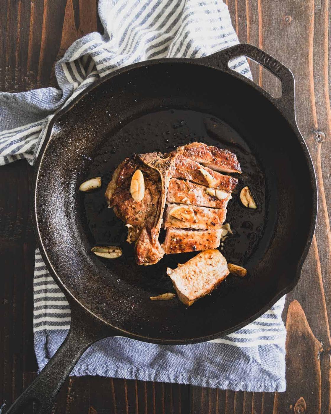 Pork chop in a cast iron skillet.
