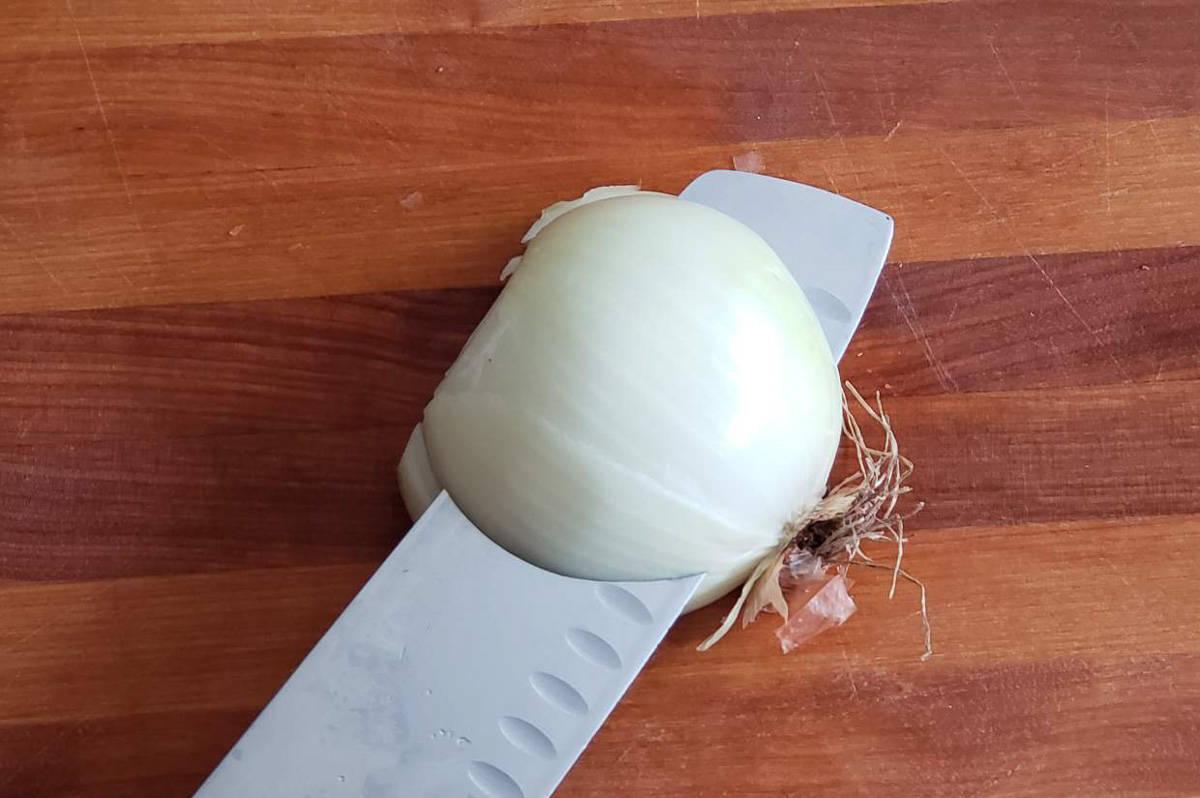 Slicing an onion with a chef's knife.