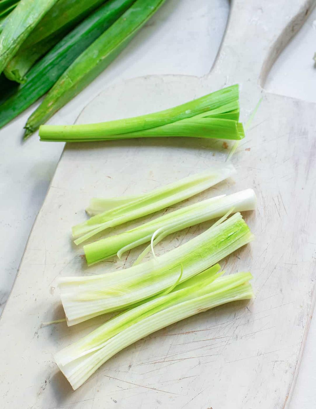 White stems of leeks sliced vertically.