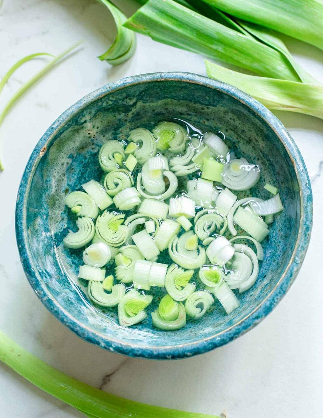Soaking cut leeks in a bowl of water.