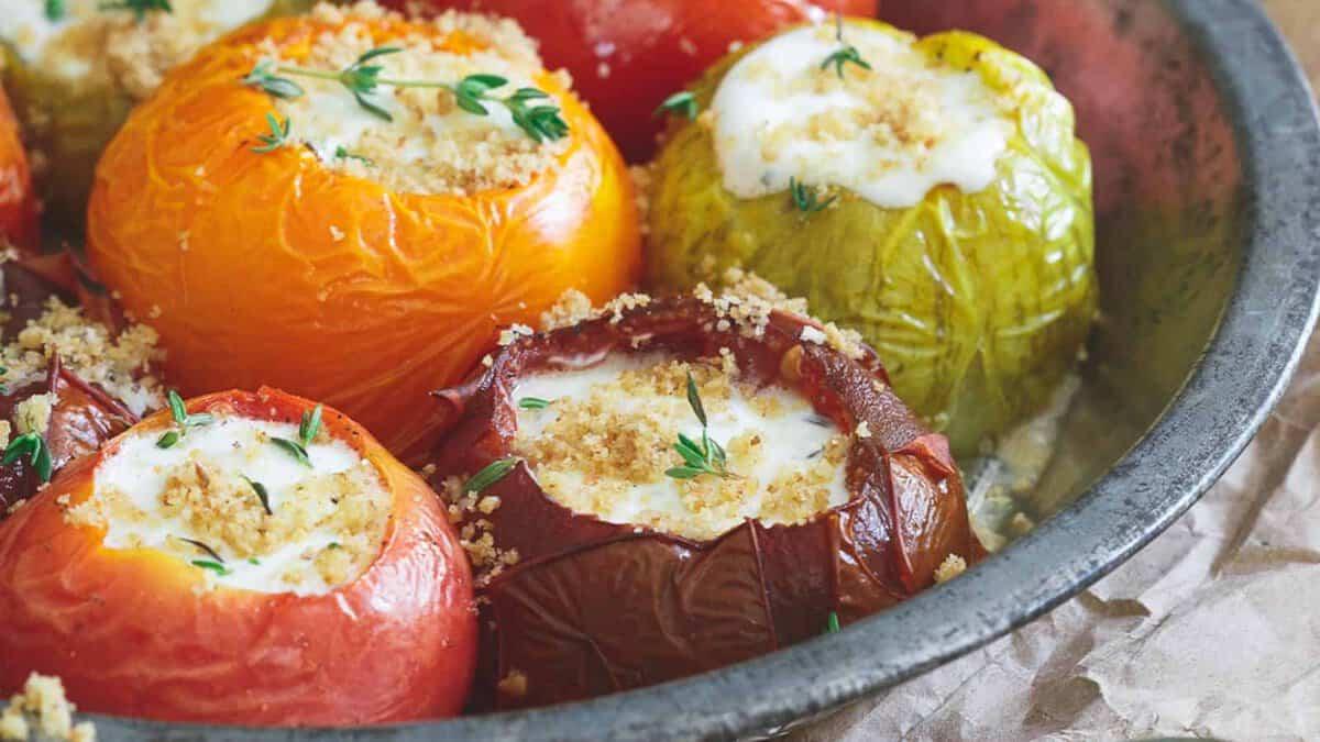 Stuffed tomatoes in a metal bowl.