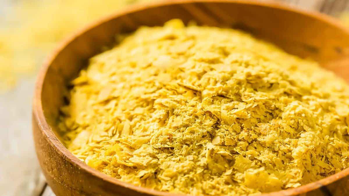 A bowl of yellow powder in a wooden bowl.