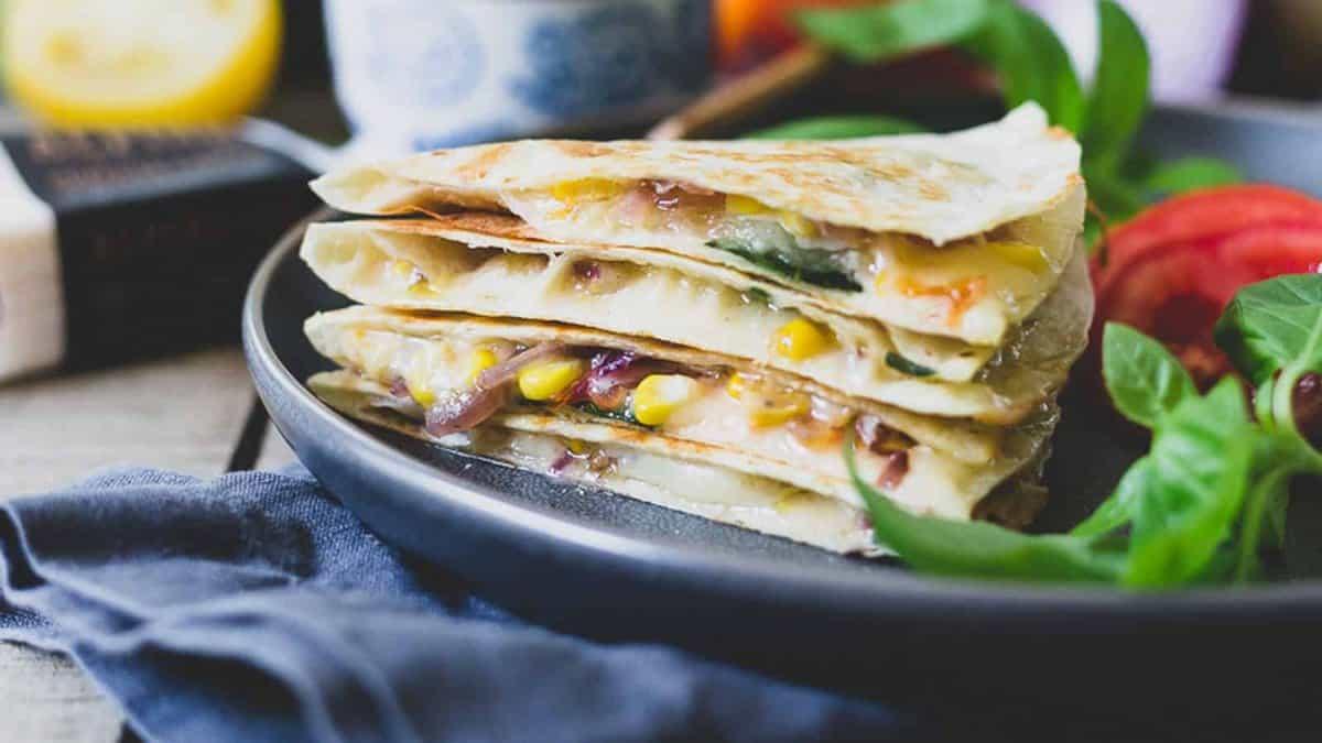 A stack of quesadillas on a plate.