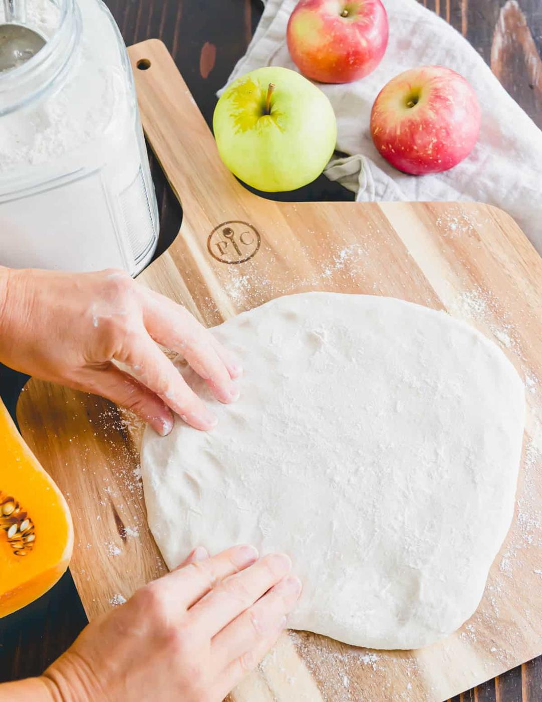 making the dough on a pizza peel for hummus pizza