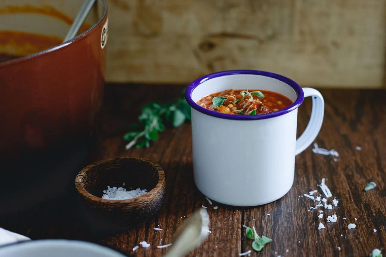 Tomato Pasta Soup is filled with beef, sausage, acini de pepe pasta, mushrooms and escarole for a hearty cozy meal.