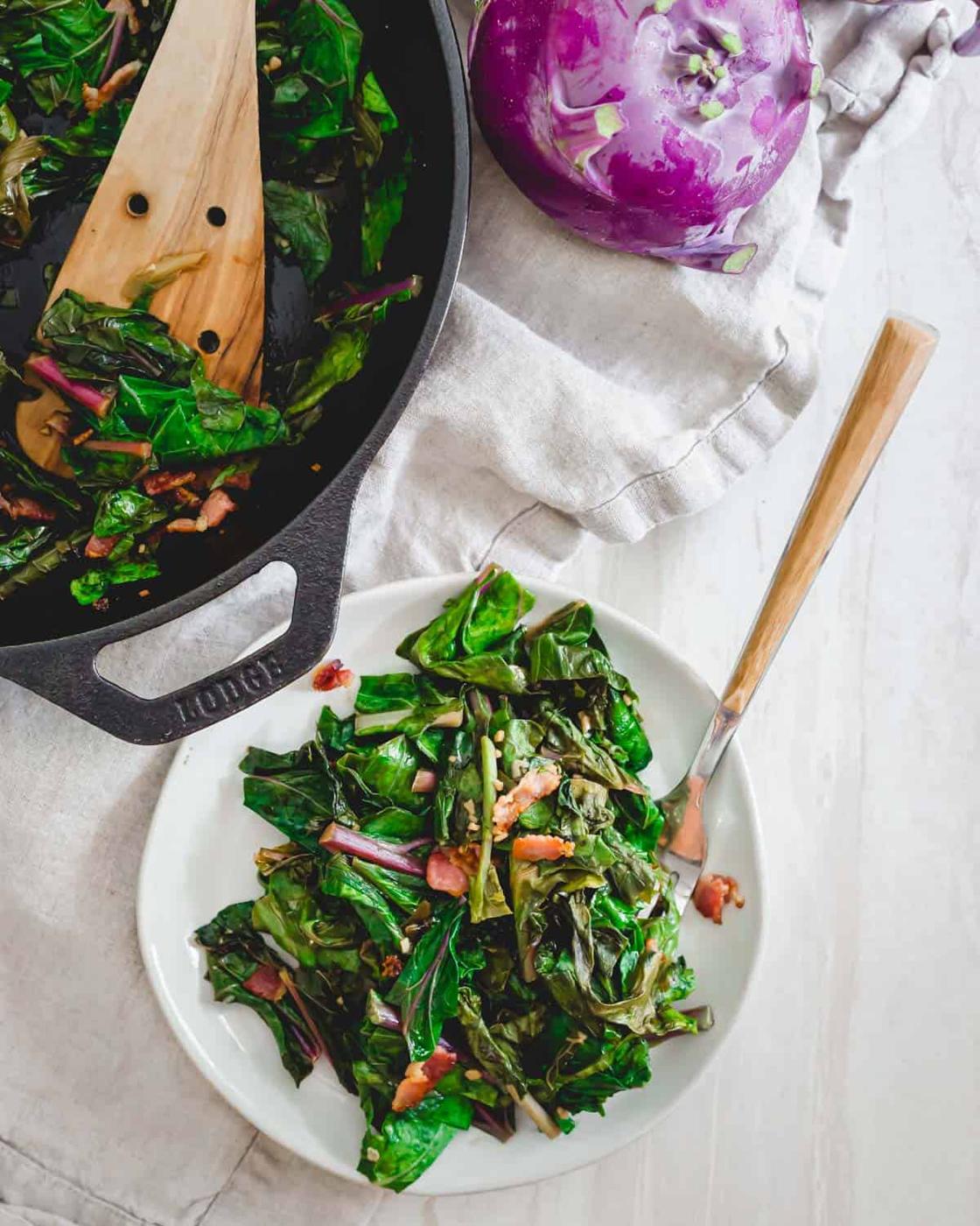Leafy kohlrabi greens sautéed until tender with garlic, green onions and topped with crispy bacon.