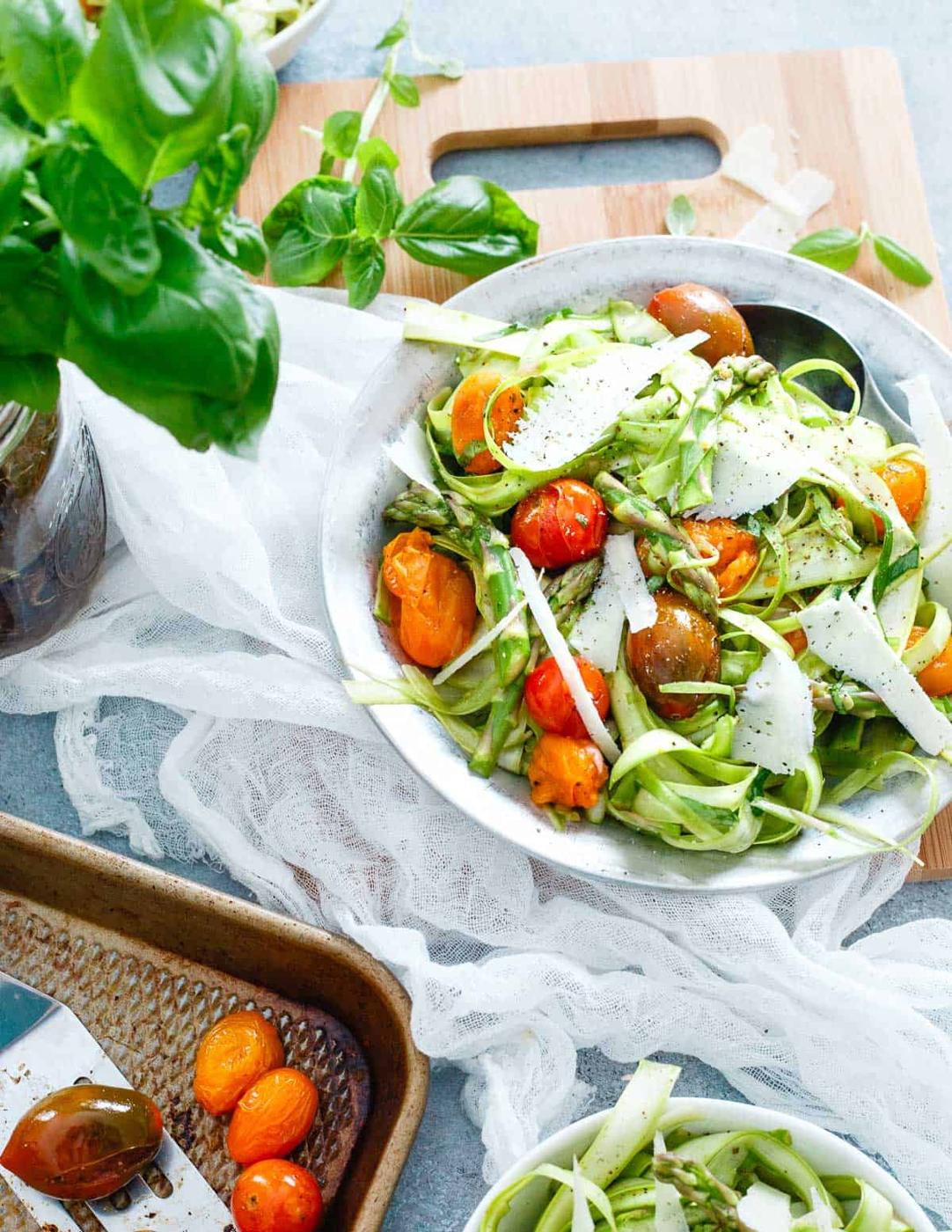 Thinly shaved asparagus makes a delicious spring salad when combined with roasted tomatoes, basil and lots of bright lemon!