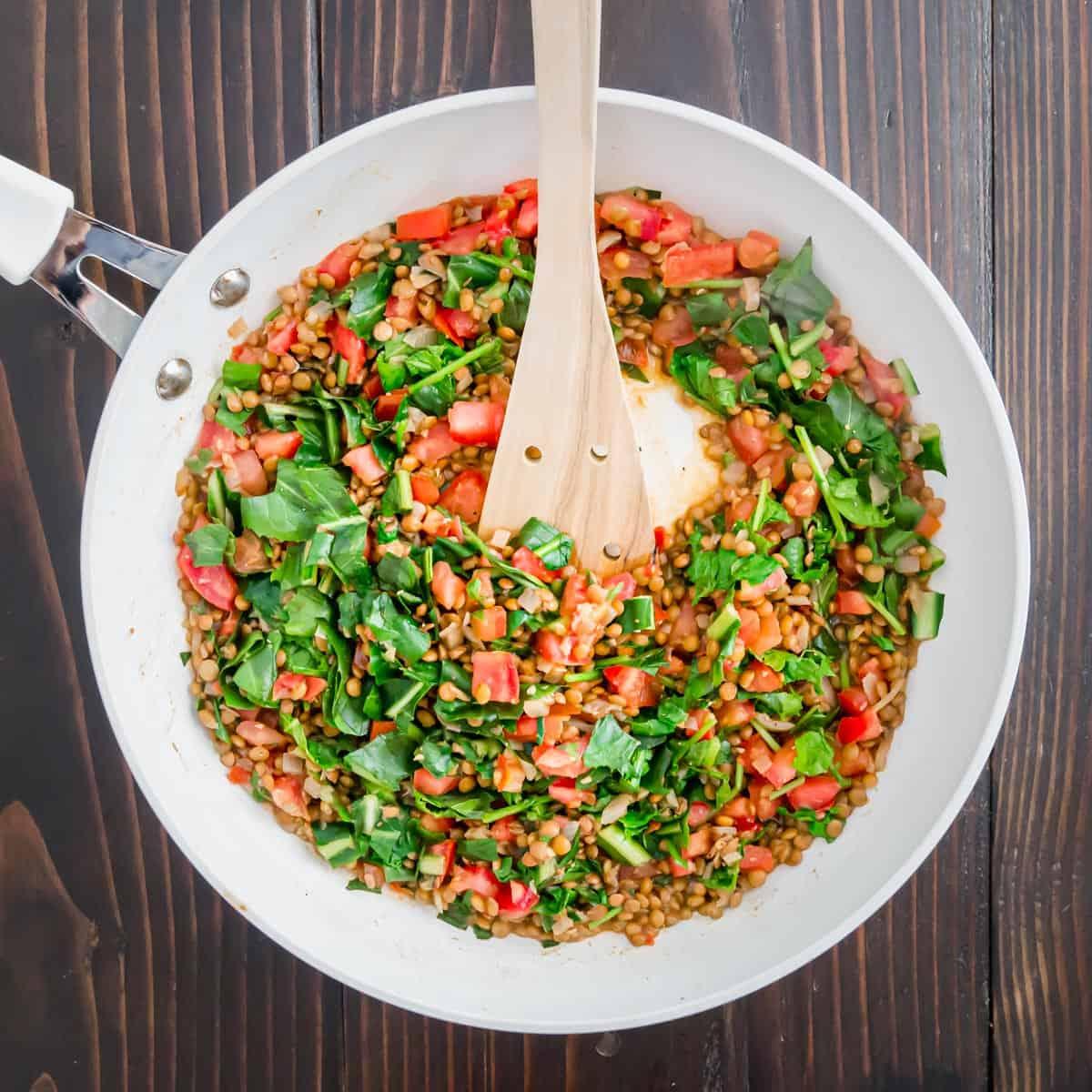 Cooked lentils, tomatoes, shallots, garlic and baby greens become a vegetarian stuffing for eggplant.