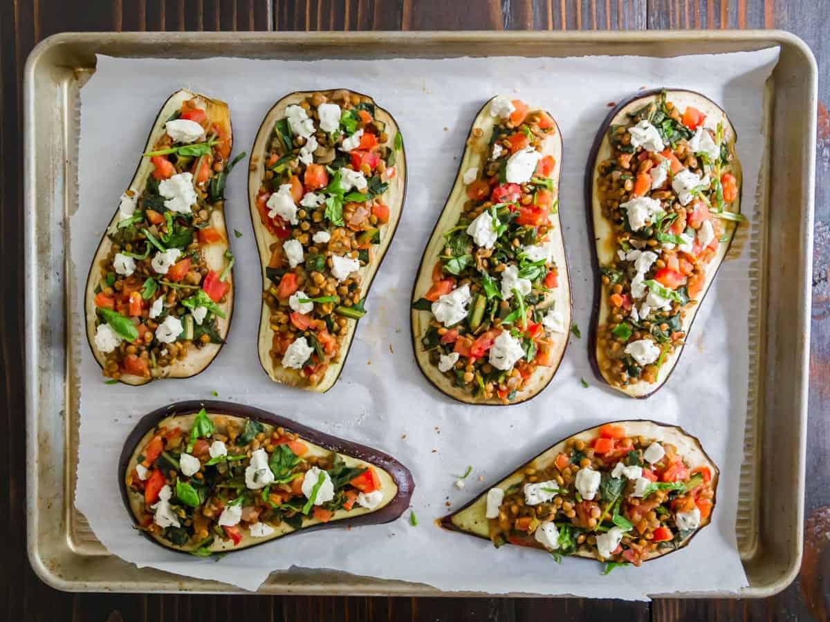 Eggplant slices topped with a lentil, tomato, greens stuffing and dollops of goat cheese.