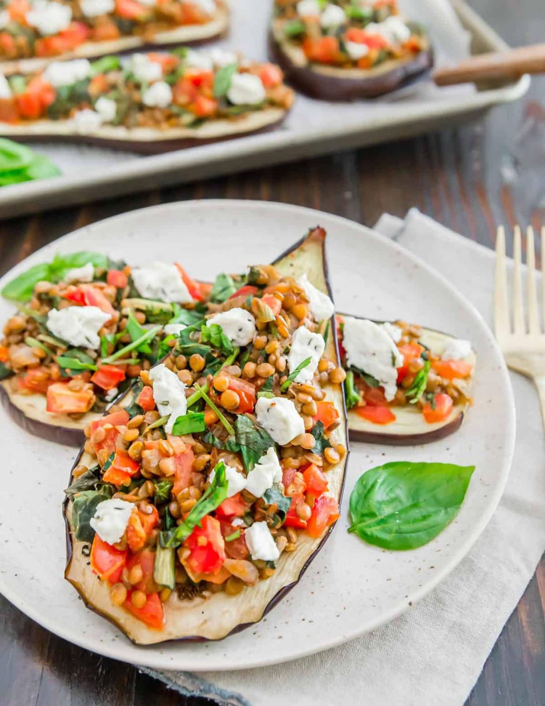 Eggplant slices stuffed with a vegetarian mixture of lentils, tomatoes, greens and goat cheese.