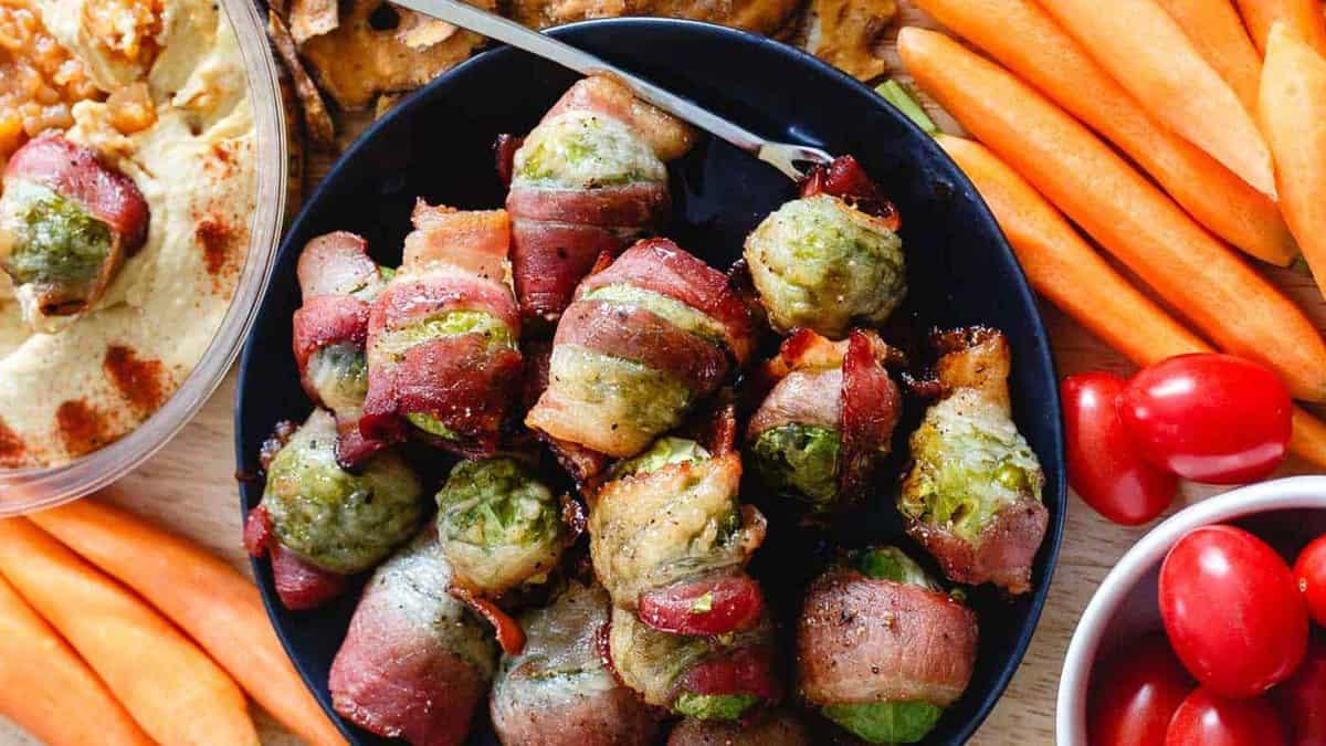 Brussels sprouts wrapped in bacon on a plate.