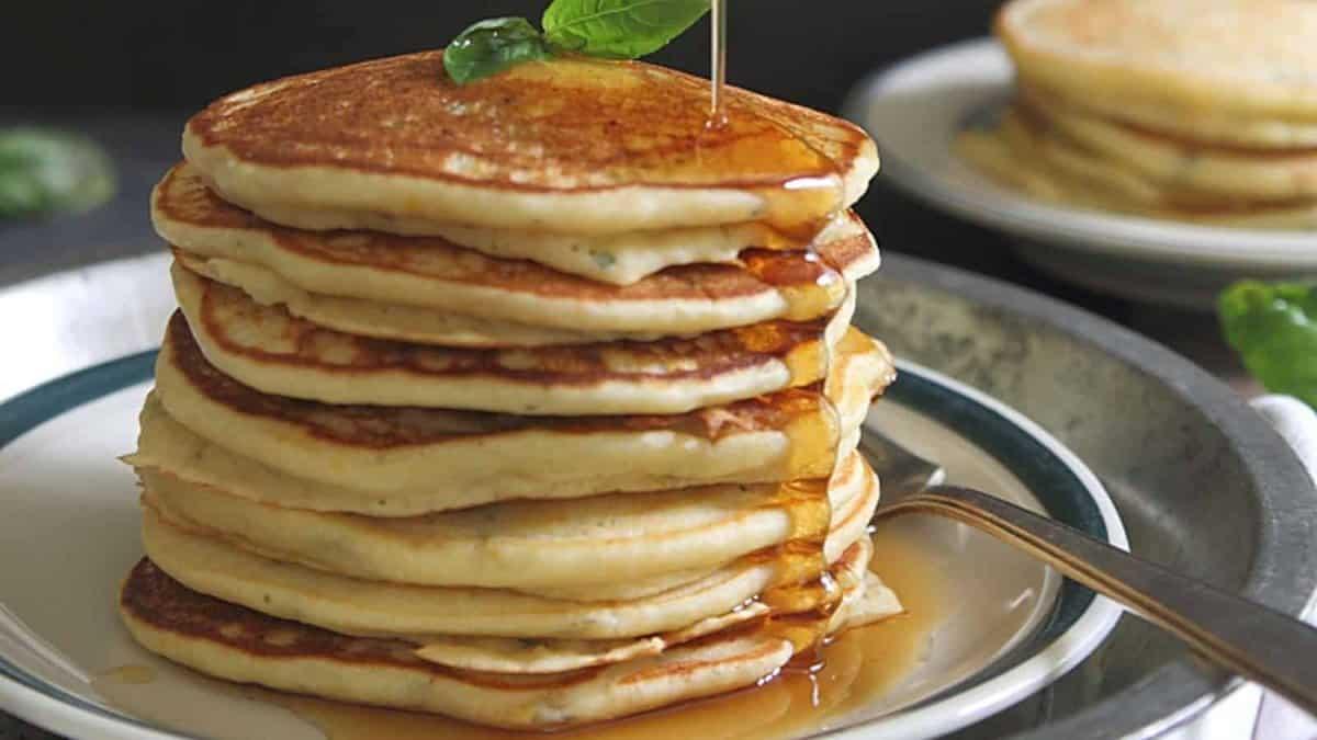 A stack of pancakes with syrup on a plate.