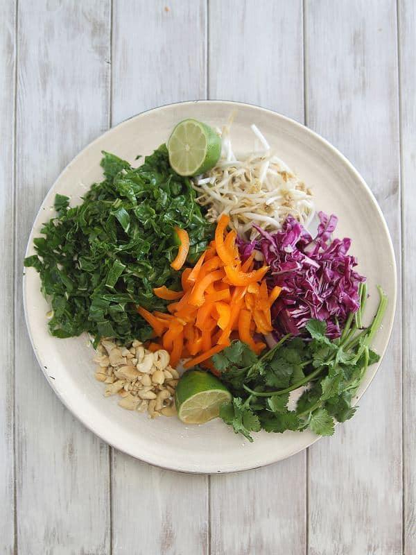 Raw pad Thai salad ingredients on a plate before the dressing has been added.