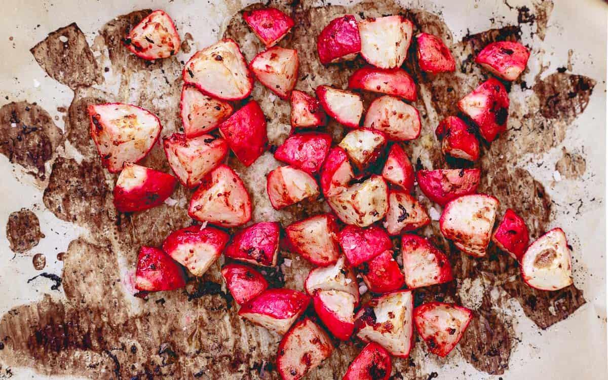 Radishes roasted with olive oil, lemon and mustard are a delicious addition to this spring pea risotto.