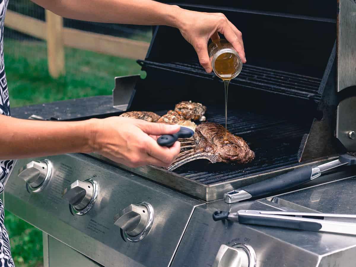 Peach honey is used to glaze American lamb chops on the grill for a sweet crispy exterior.