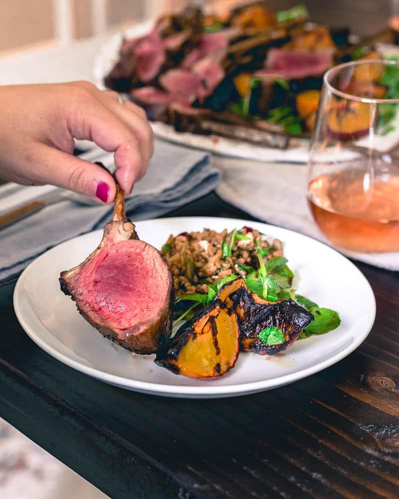 Medium rare grilled lamb chops with grilled peaches and a simple watercress salad is easy and impressive for a summer grill out!