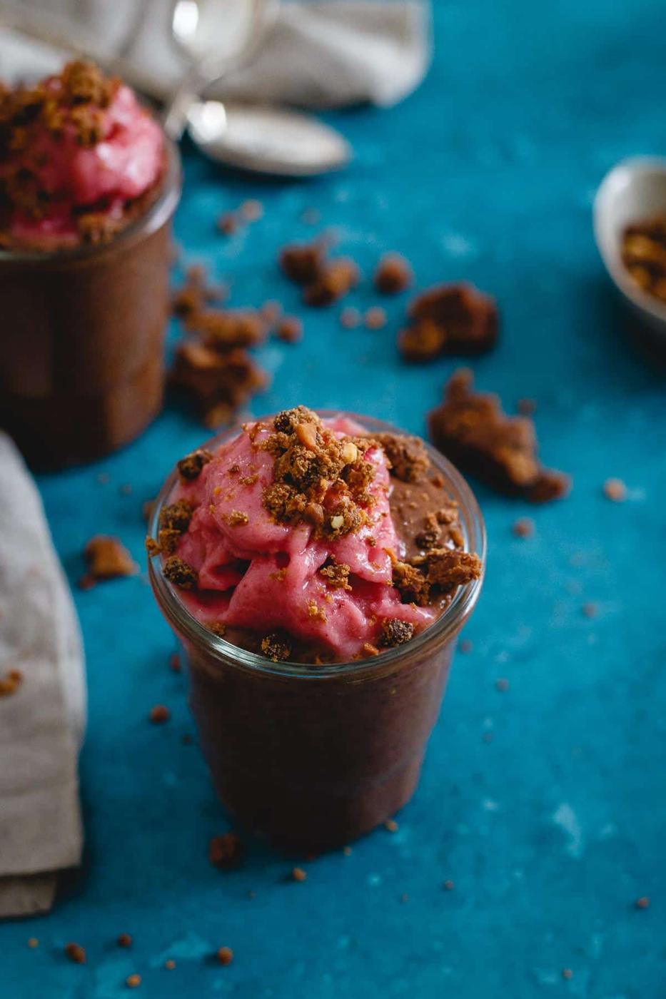This peanut butter chocolate chia pudding is a healthy dessert parfait topped with whipped frozen strawberries and peanut butter chocolate chip LARABAR crumbles.