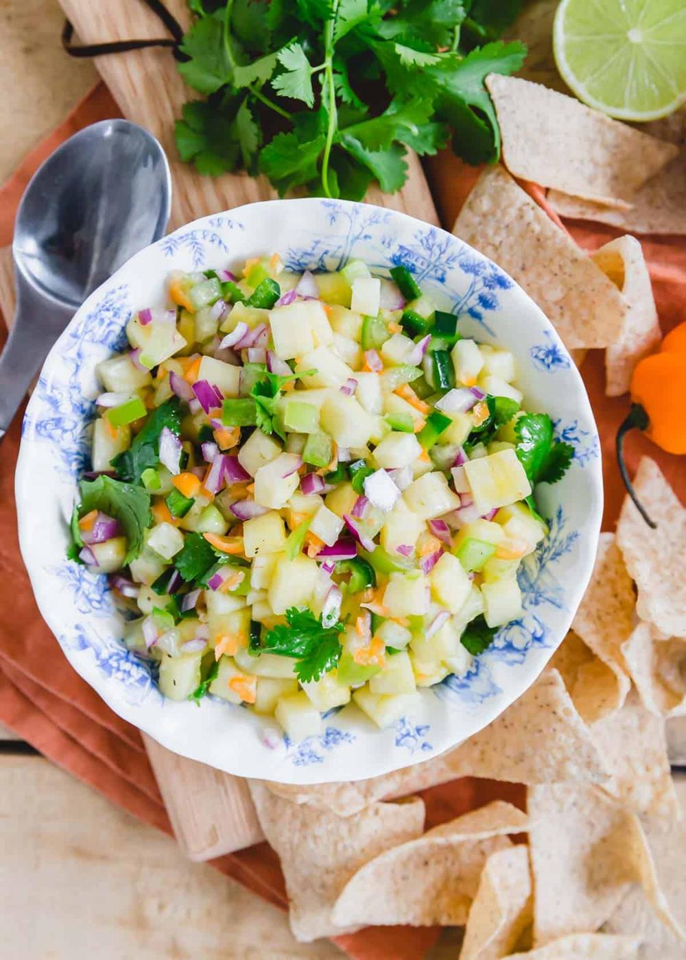 Habanero pineapple salsa in a blue and white howl with tortilla chips on the side.