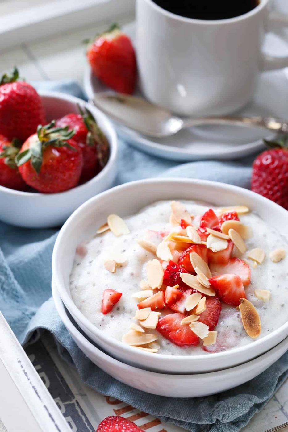 These protein packed polenta breakfast bowls are made with creamy coconut milk and filled with juicy ripe spring strawberries for a sweet start to the day.