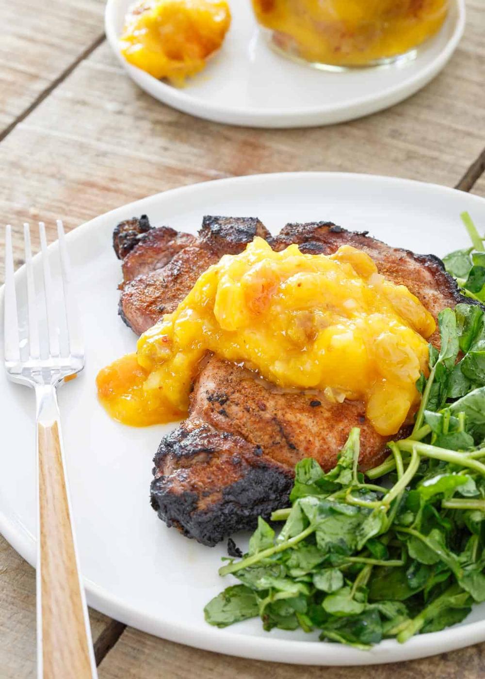 Spice Rubbed Pork Chops are topped with Mango Peach Chutney for a sweet and spicy bite.