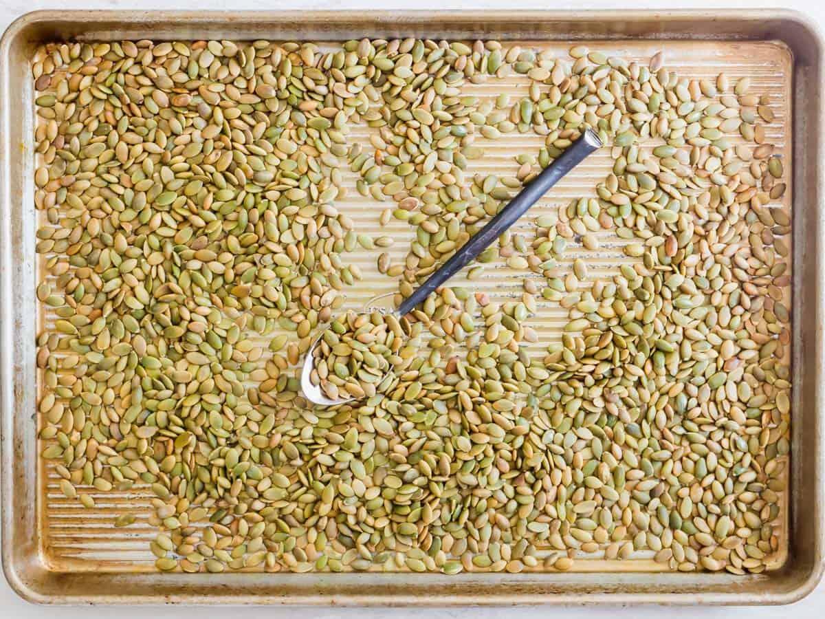 Roasted pepitas on a baking sheet.