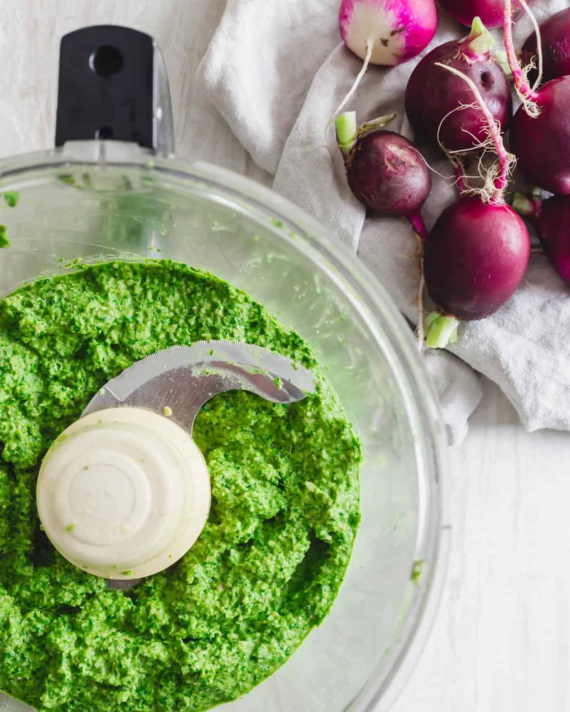 Processed radish greens pesto in a food processor.