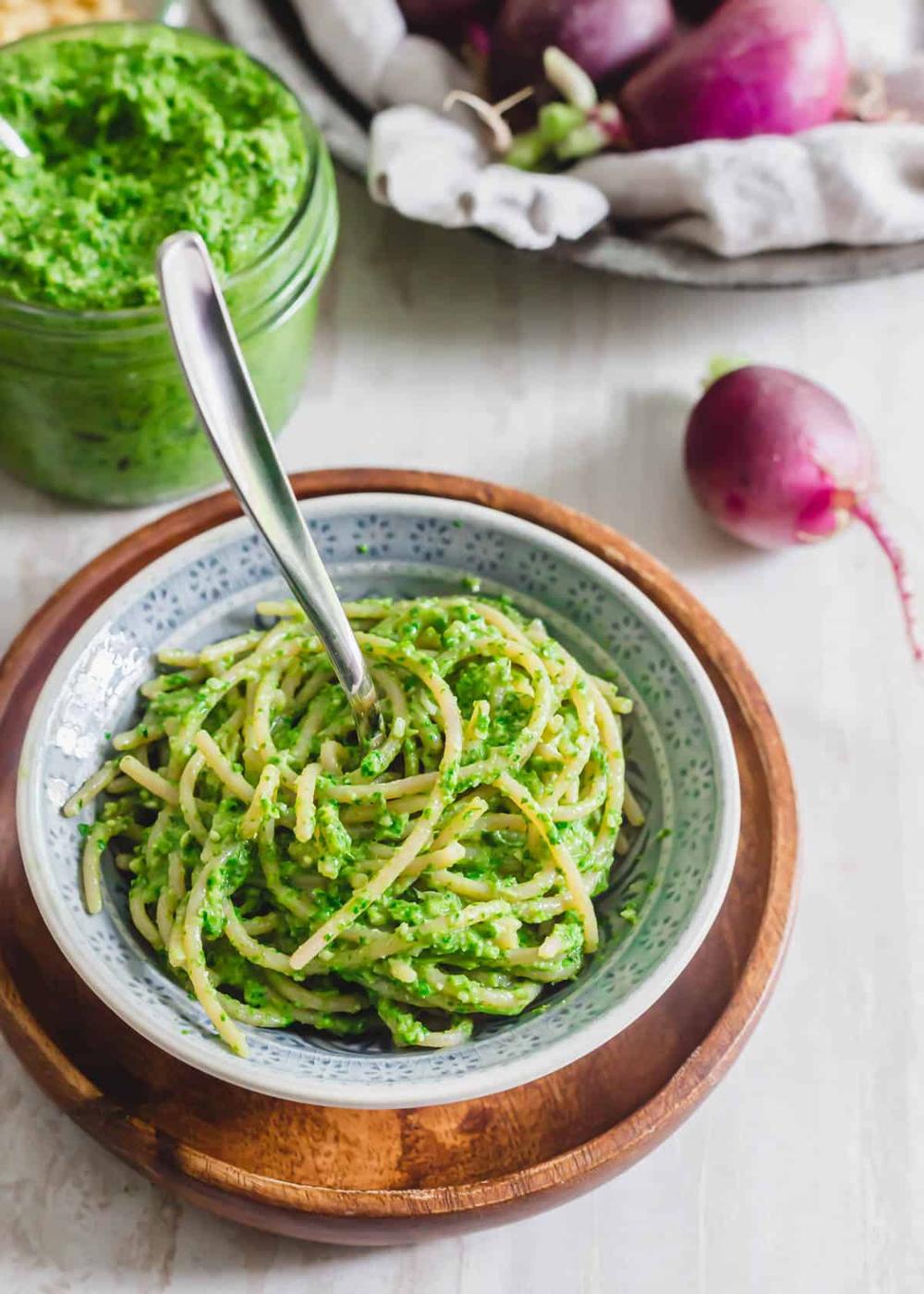 Spaghetti and radish greens pesto in a bowl.