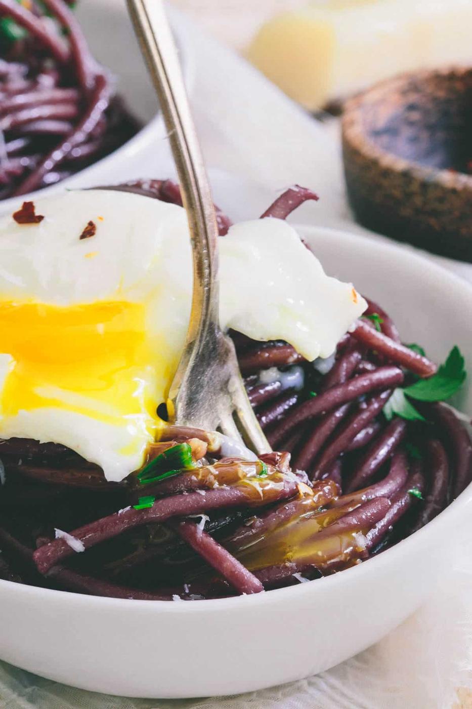 Cooking the pasta in red wine gives this bucatini it's gorgeous color. Top with a soft boiled egg for an easy meal!
