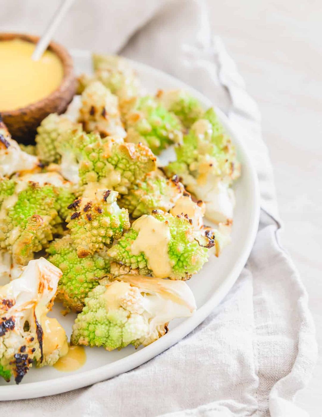 crispy oven roasted romanesco florets served with a creamy turmeric tahini sauce