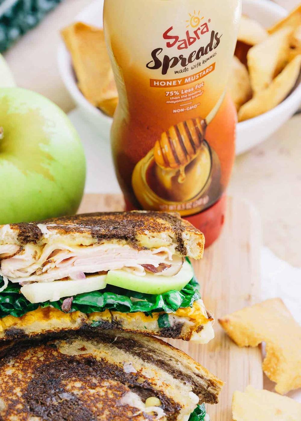 This roasted sweet potato apple ham sandwich has a tangy sweet honey mustard spread, melted cheddar cheese and caramelized red onions all piled high for one delicious bite!