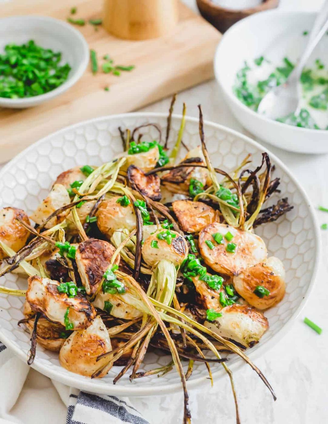 Oven roasted turnips with crispy stems drizzled in a ghee and chive sauce.