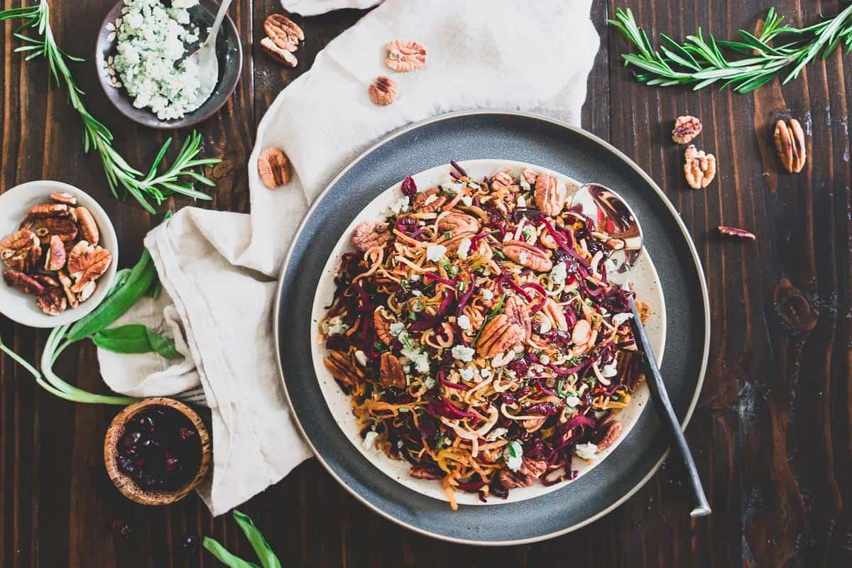 Spiralized beets and parsnips tossed with toasted pecans, dried cranberries, blue cheese crumbles and balsamic vinegar make this roasted winter root vegetable salad an explosion of seasonal flavors.