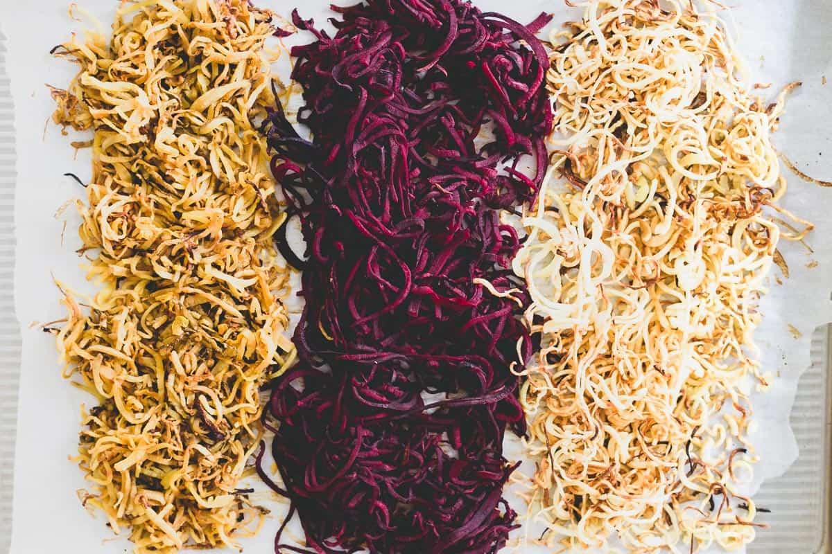 Spiralized winter root vegetables with toasted pecans, cranberries and blue cheese make a festive holiday side dish.