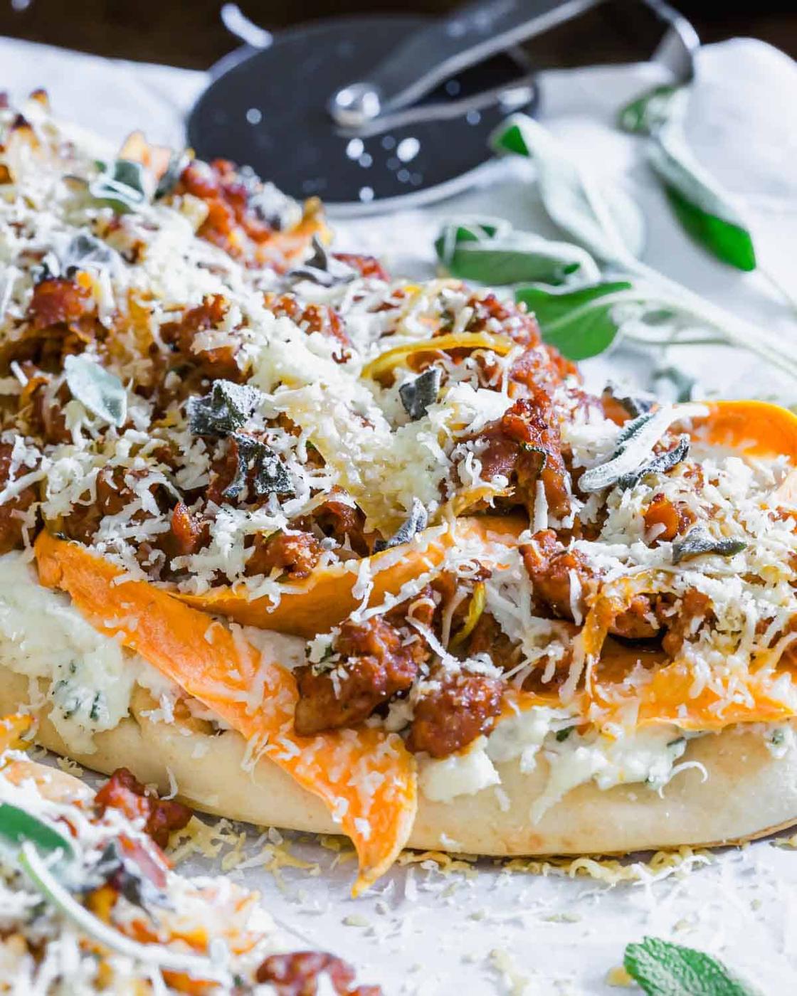 Naan pizza with meat and cheese on it.