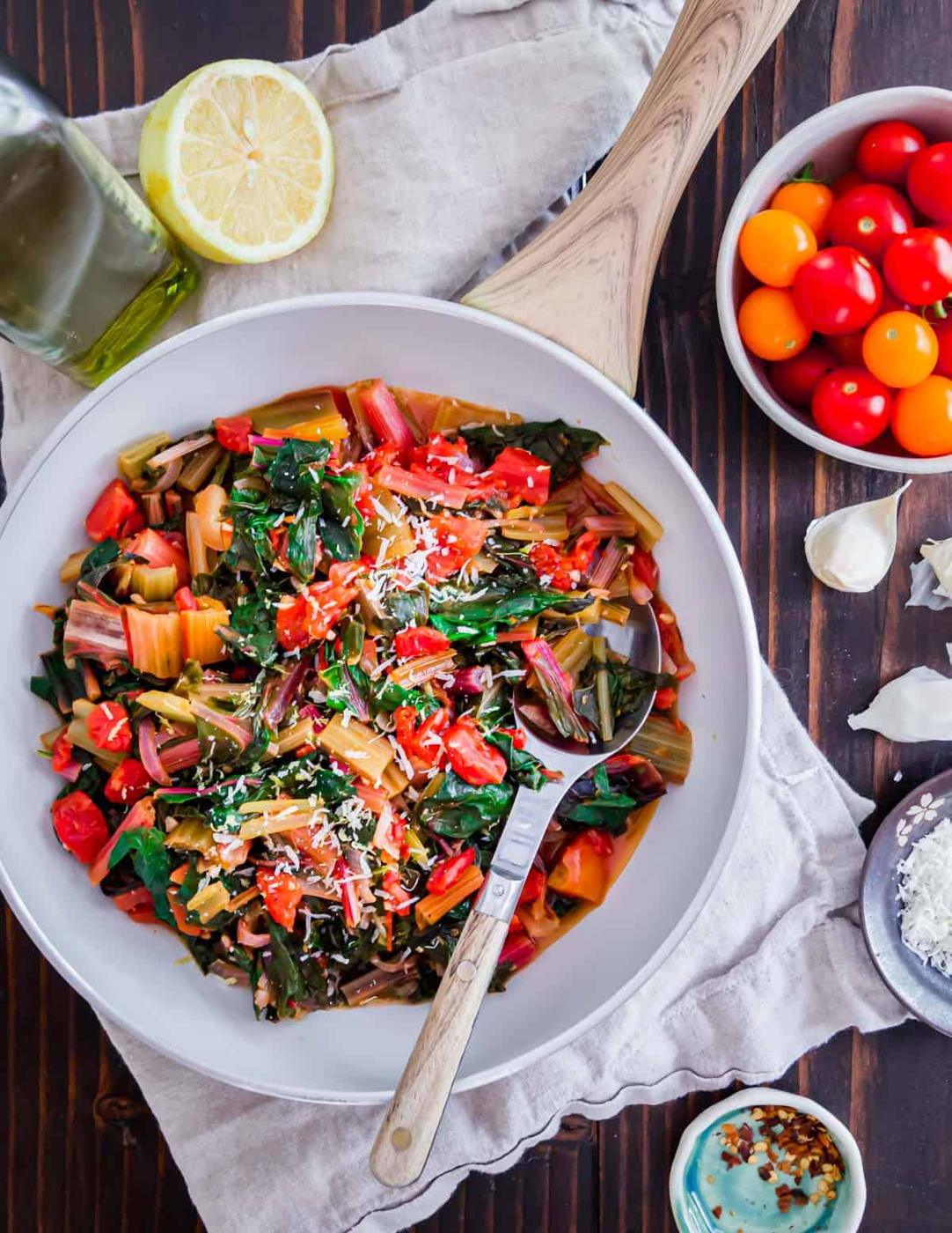 Easy sautéed Swiss chard with tomatoes, onions, garlic and lemon make a delicious and healthy vegetable side dish for summer.