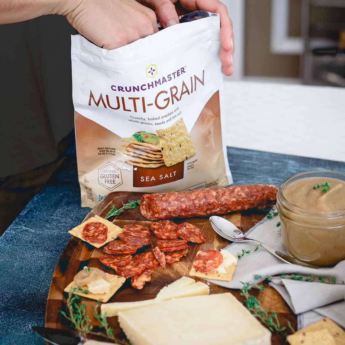 Crunchmaster multi-grain crackers are the perfect addition to a cheese, charcuterie and pear apple butter spread.