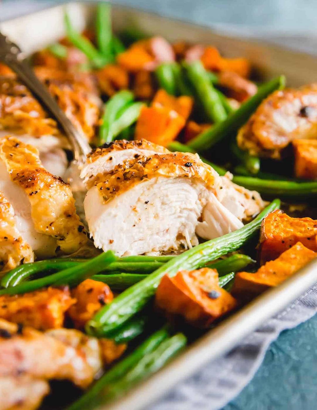 Moist, tender piri piri spiced chicken is roasted on a sheet pan with green beans and sweet potatoes for an easy complete dinner.