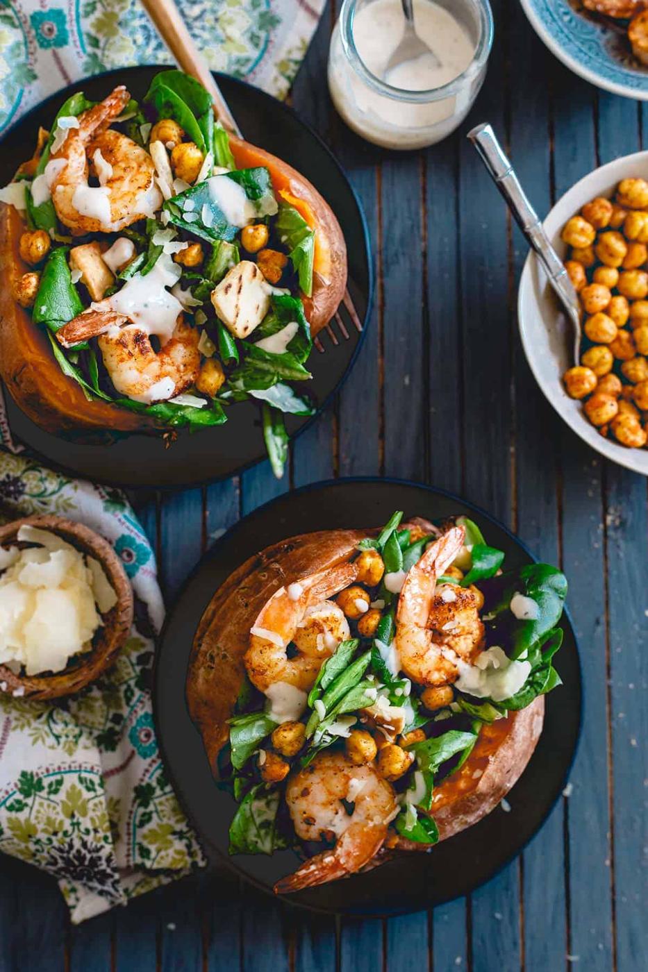 Spicy shrimp and roasted chickpeas add a bunch of flavor and satiety to these caesar salad stuffed sweet potatoes.