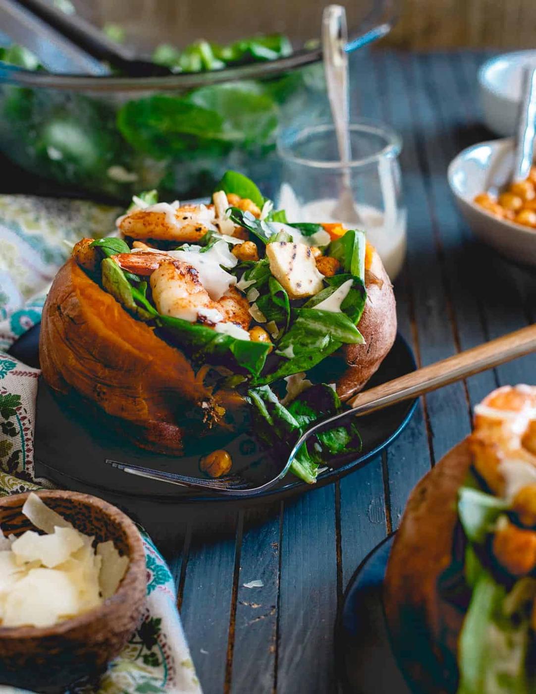 Caesar salad stuffed sweet potatoes with shrimp and chickpeas are perfect for a healthy meal not shy on flavor!