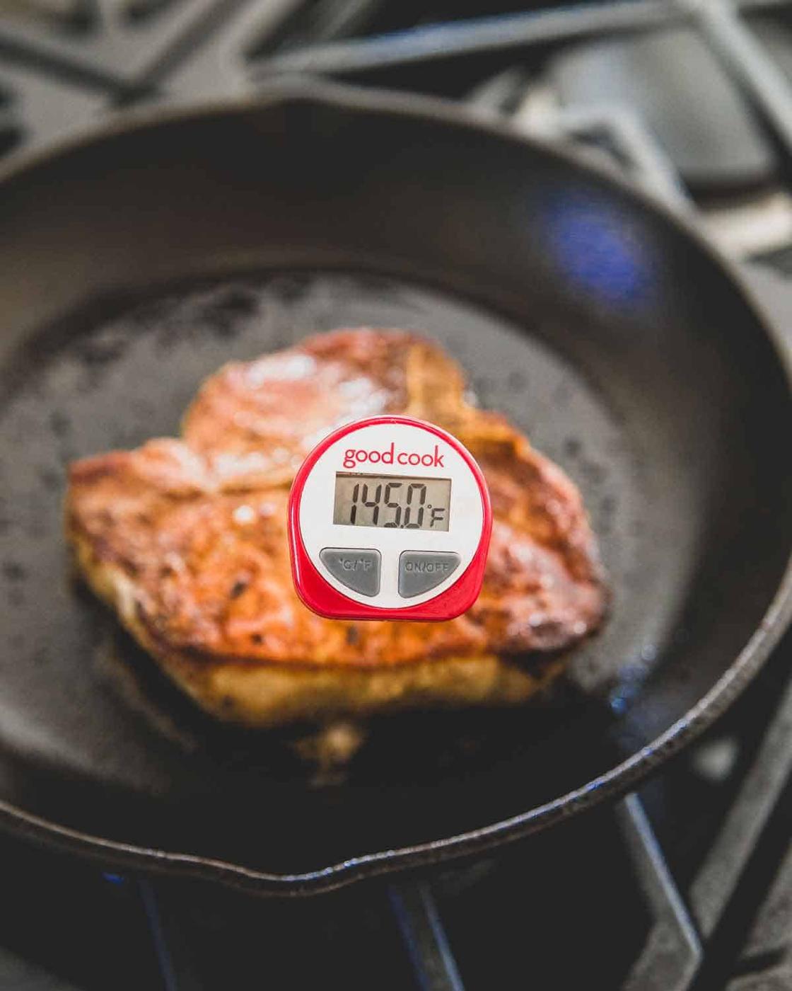 Cook skillet pork chops until an instant read thermometer hits 145 degrees Fahrenheit then let rest for 3 minutes for medium rare.